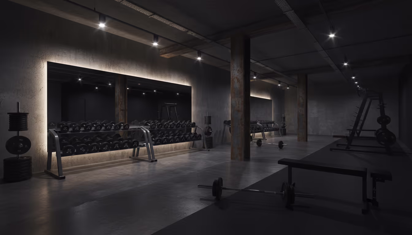 Modern gym aesthetic — moody dark gym with dramatic overhead lighting, heavy weights, mirrors, raw intensity